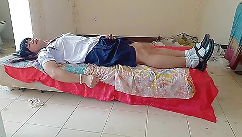 Asian schoolgirl in a uniform gets naked in the park